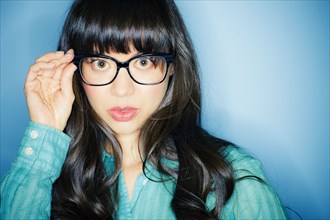 Serious mixed race woman in eyeglasses