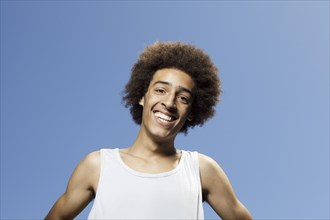 Smiling mixed race teenager standing outdoors