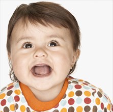 Close up of laughing hispanic baby girl