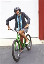 Mixed race woman in helmet standing with bicycle