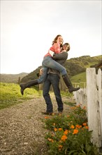 Couple hugging in rural landscape