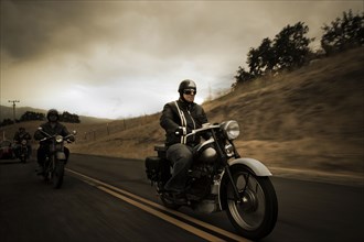 Group riding motorcycles on rural road