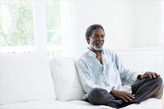 Senior man relaxing on sofa