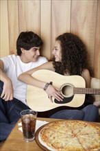 Girlfriend playing guitar for boyfriend