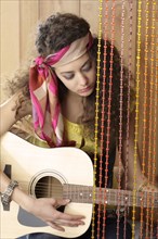 Hispanic girl playing guitar
