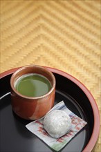 Japanese green Matcha tea and mochi sweet on tray