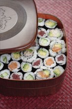 Variety of sushi rolls in box