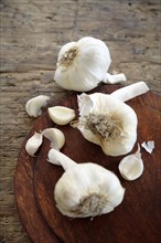 Bulbs of garlic on cutting board