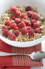 Fresh raspberries in bowl granola cereal