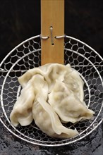 Asian dumplings in strainer