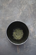 Dried sencha tea in tea cup