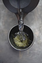 Water being poured on tea leaves