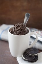 Close up of mug of ice cream and cookies