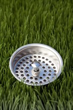 Close up of sink strainer in grass