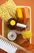 Close up of basket of cleaning supplies