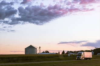 Colorful sunset over farm in rural landscape