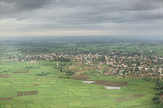 Clouds over village in rural landscape