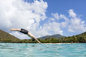 Caucasian man diving into tropical ocean