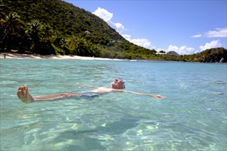 Caucasian man floating in tropical ocean