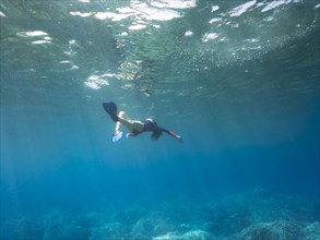 Caucasian woman snorkeling in tropical ocean