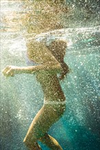 Mixed race woman swimming in ocean