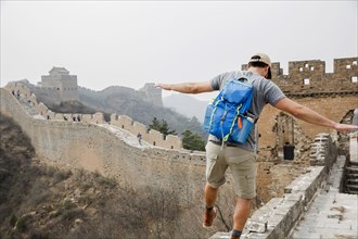 Tourist balancing on Great Wall of China
