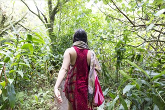 Caucasian woman walking in forest