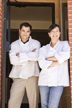 Chinese chefs standing in restaurant doorway