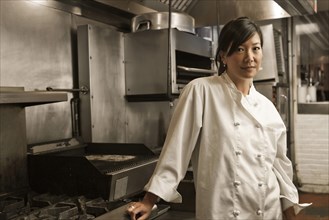 Chinese chef standing in commercial kitchen