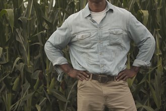 African American farmer standing with hands on hips