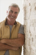 Caucasian man leaning against wall