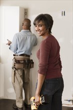Couple working in unfinished room
