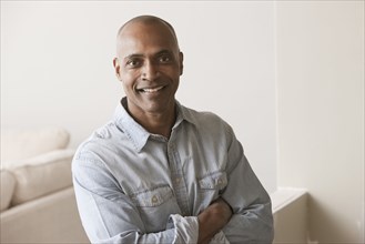 Smiling African American man standing in unfinished room
