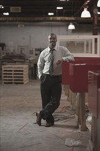Black businessman standing in warehouse