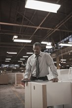 Black businessman working in warehouse