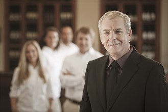 Owner and wait staff in restaurant