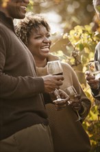 Friends drinking wine in vineyard