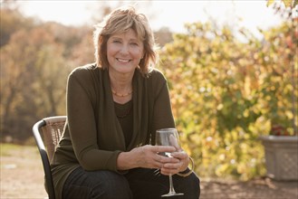 Caucasian woman drinking wine outdoors