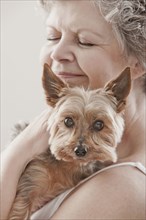 Caucasian woman holding dog