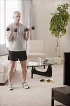 Caucasian man exercising in living room