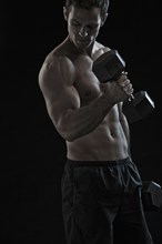 Caucasian man exercising with hand weights