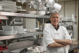 Caucasian chef standing in commercial kitchen