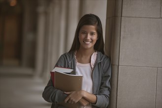 Smiling mixed race student on campus