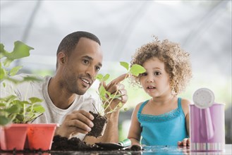 Father and daughter gardening together