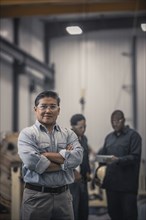 Asian worker standing in factory