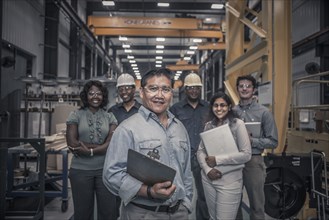 Workers standing together in factory