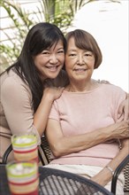 Asian mother and daughter hugging