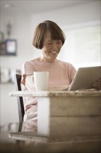 Asian woman using digital tablet
