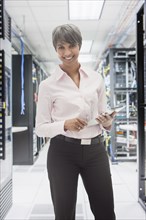 Mixed race businesswoman in server room