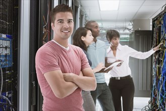 Business people standing in server room